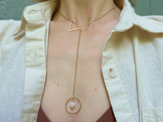 Gold lariat necklace with o ring drop featuring a moonstone, and a triangle shape