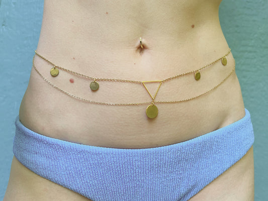 Person wearing a golden bollywood style belly chain with layered chains and coins