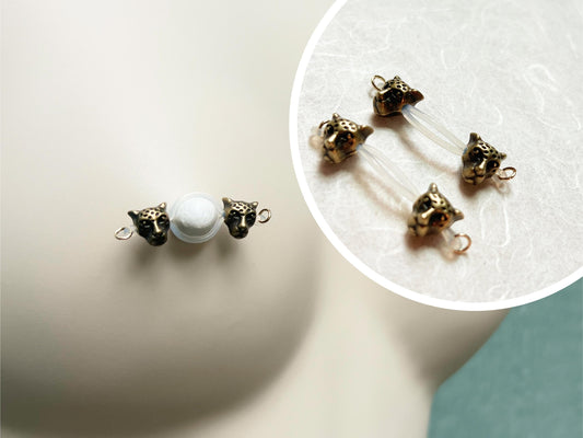 nipple jewelry with leopard heads, leopard barbell nipple piercing, fake nipple piercing with wild cats, cougar nipple jewelry